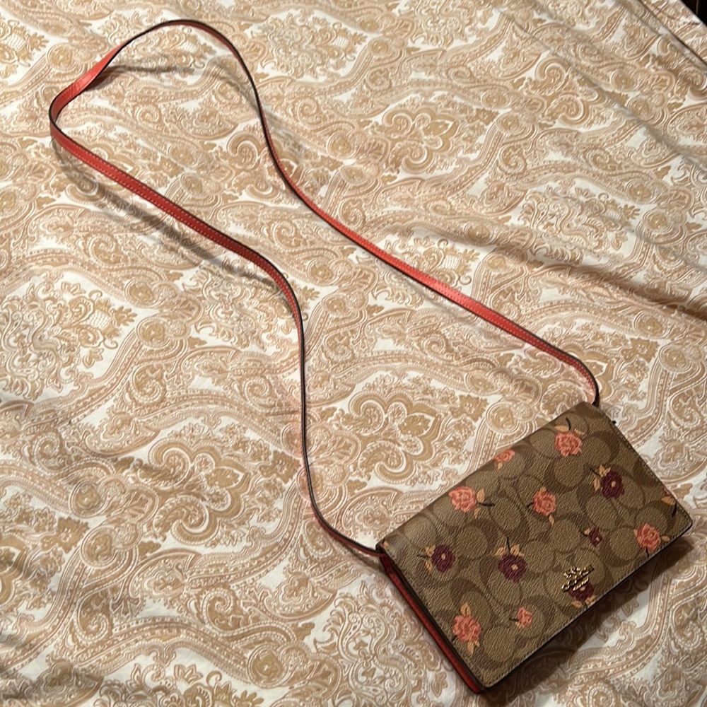 Small crossbody Coach bag with floral design